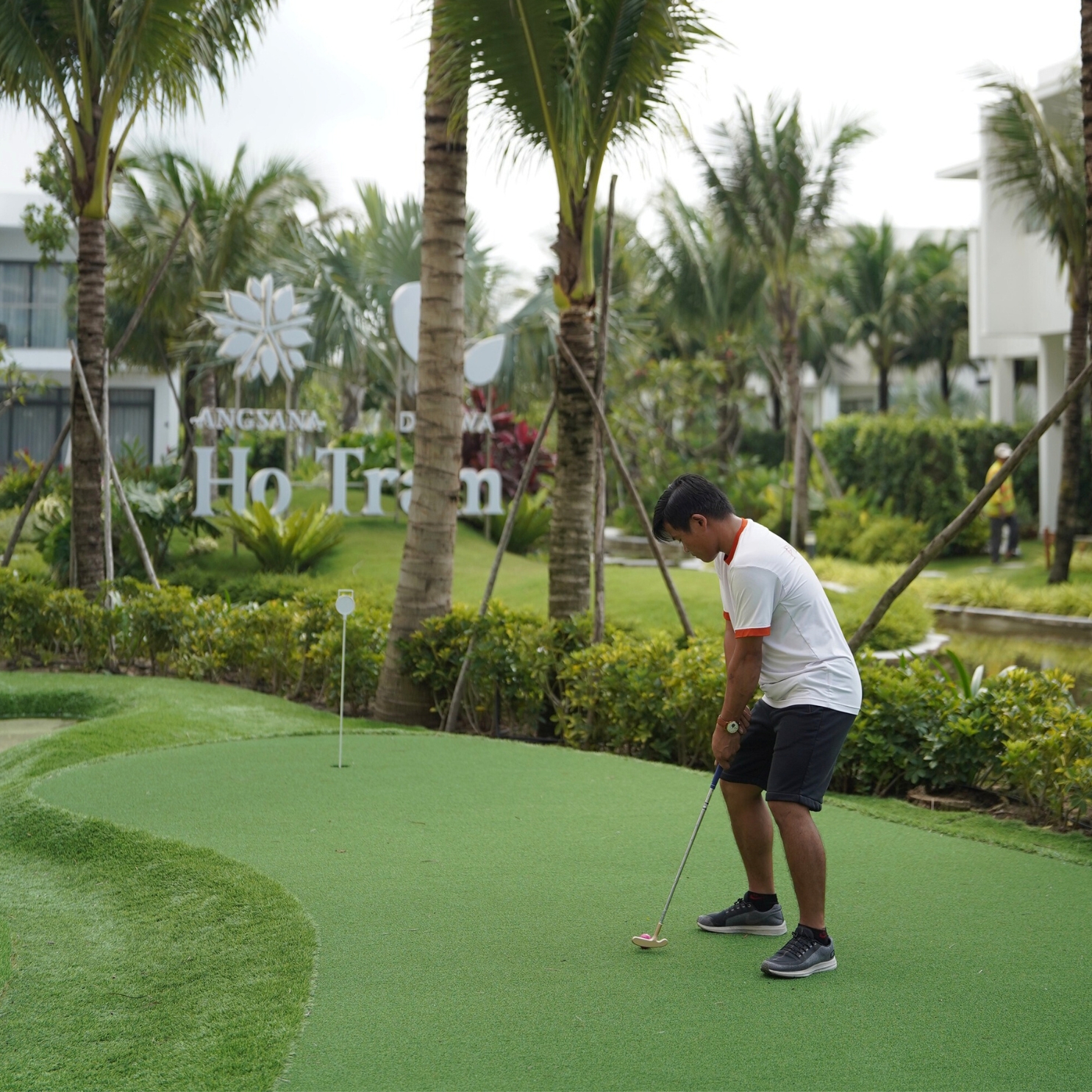 A man playing mini golf.